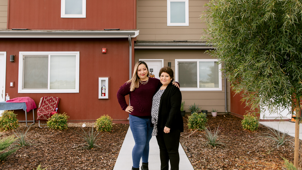 Claudia Miranda and her mother Martha Baltazar outside their home at Rosaleda Village in Wasco, California